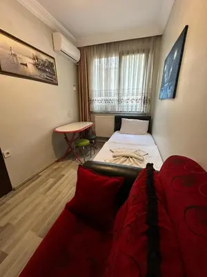 a room with a bed and a couch and a table at AWWA APART HOTEL in Istanbul