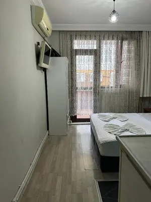 a small room with a bed and a window at AWWA APART HOTEL in Istanbul
