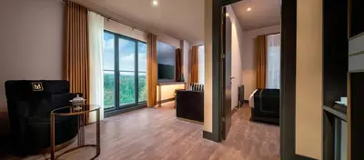 a living room with a couch and a large window at MENALO HOTEL PREMIUM ISTANBUL AIRPORT in Istanbul