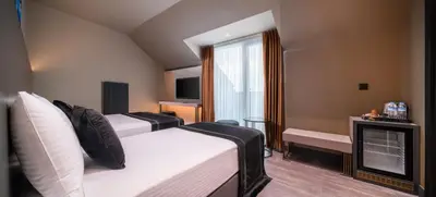 a hotel room with two beds and a fireplace at MENALO HOTEL PREMIUM ISTANBUL AIRPORT in Istanbul