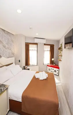 a bedroom with a large bed with white sheets at Kupa HOTEL in Istanbul