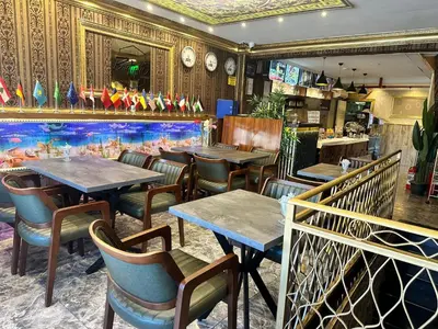 a restaurant with tables and chairs and a large aquarium at Maranda Suit Hotel in Istanbul
