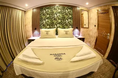 a bedroom with a large bed with a large window at Maranda Suit Hotel in Istanbul