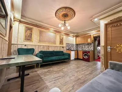 a living room with a green couch and a table at Maranda Suit Hotel in Istanbul