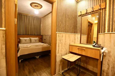 a small room with a bed and a mirror at Maranda Suit Hotel in Istanbul