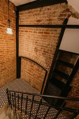 an empty room with a brick wall and a chair at Galadoo Suites in Istanbul