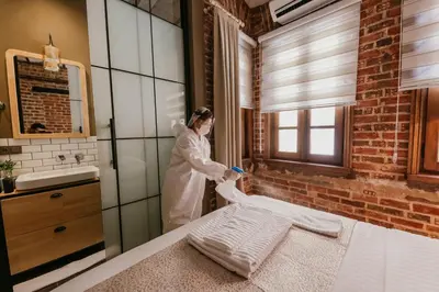 a woman standing in a bathroom with a sink at Galadoo Suites in Istanbul