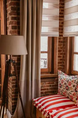 a room with a chair and a lamp and a window at Galadoo Suites in Istanbul