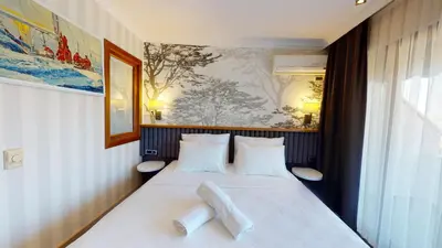 a bedroom with a bed with two white pillows at DOUBLE ROYAL HOTEL in Kocaeli
