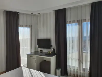 a hotel room with a bed and a television at DOUBLE ROYAL HOTEL in Kocaeli