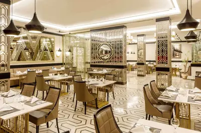 a restaurant with tables and chairs in a room at Ramada by Wyndham Istanbul Golden Horn in Istanbul