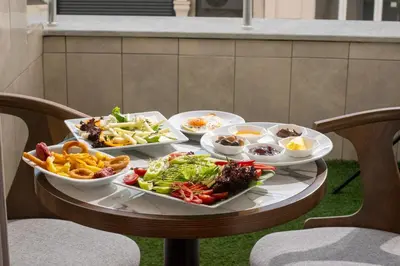 a table with several dishes of food on it at Vitabella Suites in Istanbul