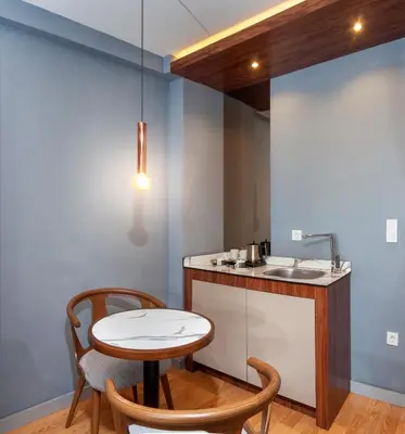 a kitchen with a table and two chairs and a sink at Vitabella Suites in Istanbul