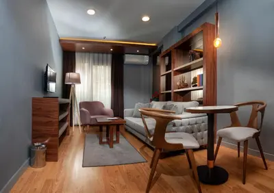 a living room with a couch and a table and chairs at Vitabella Suites in Istanbul
