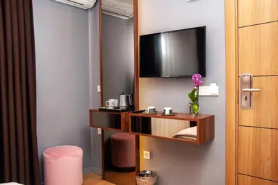a room with a flat screen tv and a desk at Vitabella Suites in Istanbul