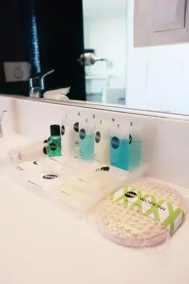 a bathroom counter with toothbrushes and a mirror at Workinn Hotel in Gebze