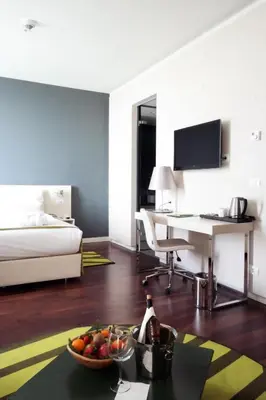 a room with a bed and a desk with a bowl of fruit at Workinn Hotel in Gebze
