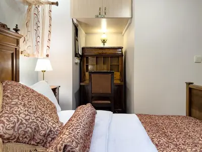 a bedroom with a bed and a desk with a chair at Antik Konak Little Hagia Sophia Suites in Istanbul
