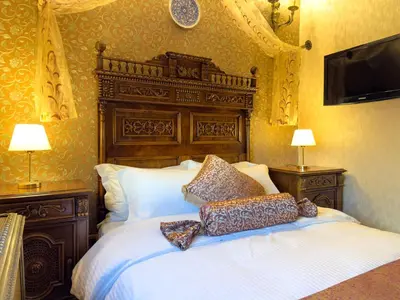 a bedroom with a large bed with two pillows on it at Antik Konak Little Hagia Sophia Suites in Istanbul