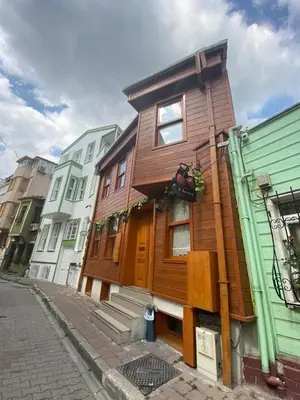 a wooden house on the side of a street at New Cherry Hotel in Istanbul