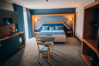 a hotel room with a bed and a table and chair at Roof 264 Hotel & Suites in Sakarya