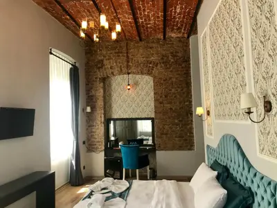 a bedroom with a bed and a brick wall at The Independent Hotel Taksim in Istanbul