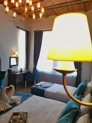 a hotel room with two beds and a lamp at The Independent Hotel Taksim in Istanbul