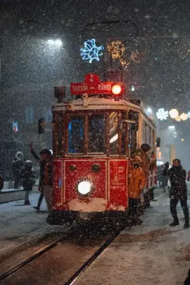 a red trolley car on the tracks in the snow at The Independent Hotel Taksim in Istanbul