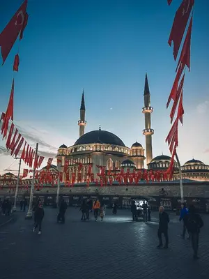 a building with two mosques with flags in front of it at The Independent Hotel Taksim in Istanbul