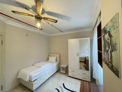 a bedroom with a bed and a ceiling fan at Apart Point in Istanbul