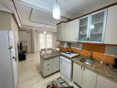 an empty kitchen with a sink and a refrigerator at Apart Point in Istanbul