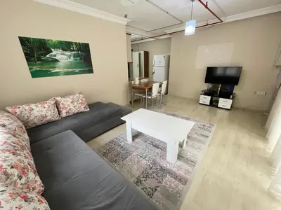 a living room with a couch and a table at Apart Point in Istanbul