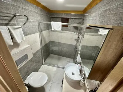 a bathroom with a shower and a toilet and a sink at Golden Sail Hotel Old City in Istanbul