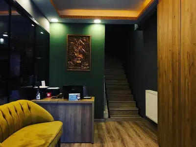 a lobby with a staircase and a green wall at Golden Sail Hotel Old City in Istanbul