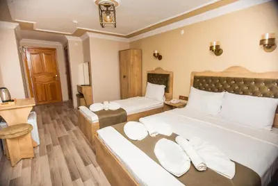 a bedroom with two beds with white pillows at Hotel Orkide in Istanbul