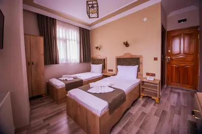 a bedroom with two beds in a room at Hotel Orkide in Istanbul