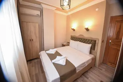 a small bedroom with a bed with two pillows on it at Hotel Orkide in Istanbul