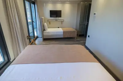 a hotel room with a bed and a tv at Mardia Hotel in Istanbul