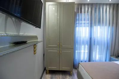 a bedroom with a cabinet next to a bed at Mardia Hotel in Istanbul