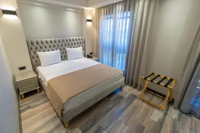 a bedroom with a large bed and a chair at Mardia Hotel in Istanbul