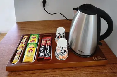 a tray with a coffee pot and some sushiachiachi at Class Hotel Bosphorus With Jacuzzi in Istanbul