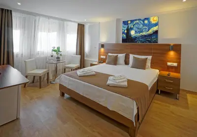 a hotel room with a large bed and a table at Class Hotel Bosphorus With Jacuzzi in Istanbul