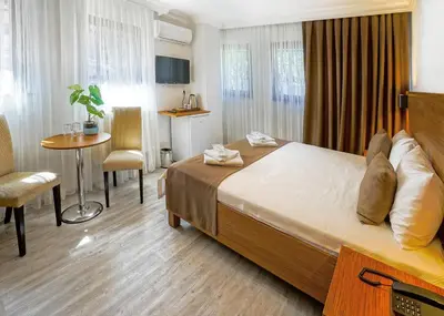 a hotel room with a bed and a table and chairs at Class Hotel Bosphorus With Jacuzzi in Istanbul