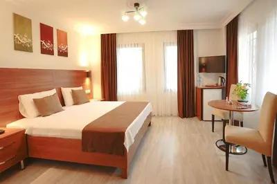 a hotel room with a bed and a table at Class Hotel Bosphorus With Jacuzzi in Istanbul