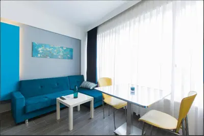 a living room with a blue couch and a table at Blue Apartment in Istanbul