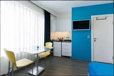 a kitchen with a table and chairs and a blue door at Blue Apartment in Istanbul