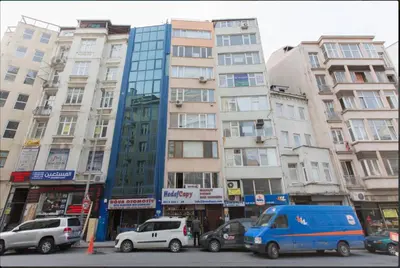 a street with cars parked in front of tall buildings at Blue Apartment in Istanbul