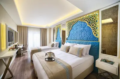 a hotel room with a large bed with a blue headboard at Great Fortune Design Hotel & Spa in Istanbul