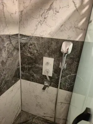 a bathroom with a shower with a phone at Ararat Apart in Istanbul