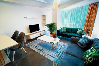 a living room with a couch and a table at Continent Luxury Suites Sakarya in Sakarya